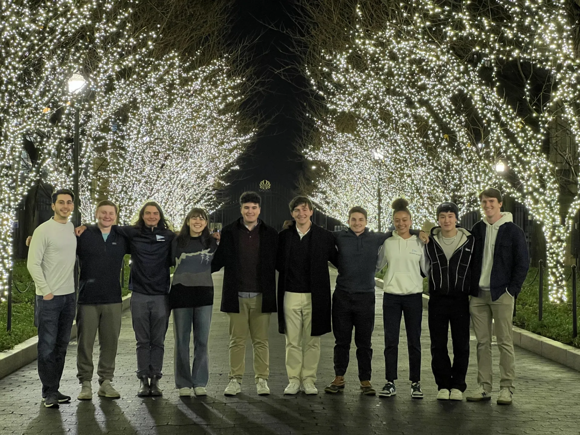 Our board members smiling beneath Columbia's holiday lights.